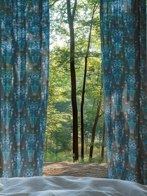 A sheer curtain panel featuring a repeating pattern of stylized owls in luminous blue tones, surrounded by delicate botanical flowers and flourishes on a dark background.